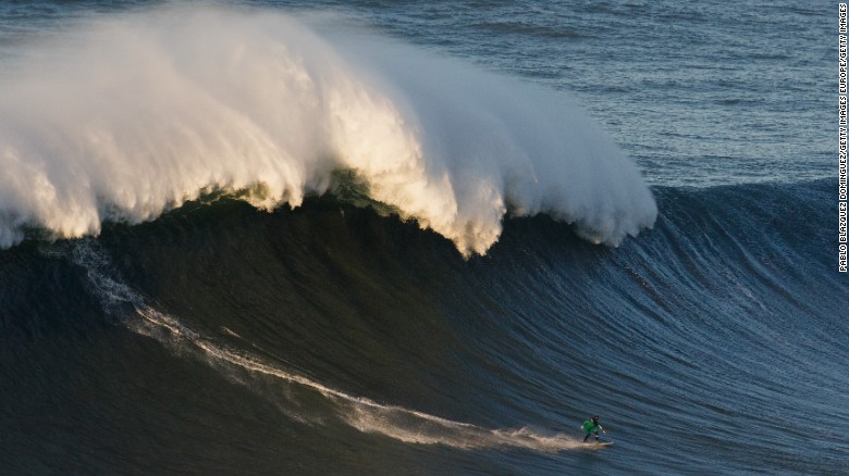 NAZARE, PORTUGAL - DECEMBER 17:  British surfer Andrew Cotton rides a big wave at Praia do Norte on December 17, 2016 in Nazare, Portugal. Nazare's giant waves are increasingly attracting surfers from around the world, as it becomes part of the World Surf League Big Wave Tour.  (Photo by Pablo Blazquez Dominguez/Getty Images)