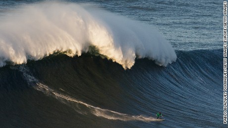 NAZARE, PORTUGAL - DECEMBER 17:  British surfer Andrew Cotton rides a big wave at Praia do Norte on December 17, 2016 in Nazare, Portugal. Nazare&#39;s giant waves are increasingly attracting surfers from around the world, as it becomes part of the World Surf League Big Wave Tour.  (Photo by Pablo Blazquez Dominguez/Getty Images)