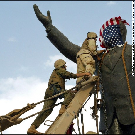 IRAQ - APRIL 09:  Operation Iraqi Freedom - Day 21: Us Troops Enter Central Baghdad And Topple Statue Of Saddam Hussein On April 9, 2003 In Baghdad, Iraq. Members Of The Us Marine 3Rd Battalion 4Th Regiment Share In The Celebration With Iraqis. Liberated By U.S. Led Troops, Thousands Of Jubilant Iraqis Celebrated The Collapse Of Saddam Hussein Murderous Regime, Beheading A Toppled Statue Of Their Longtime Ruler In The Center Of Baghdad And Looting Government Sites.  (Photo by Gilles BASSIGNAC/Gamma-Rapho via Getty Images)