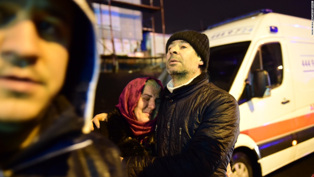 A woman is consoled at the site of the attack.