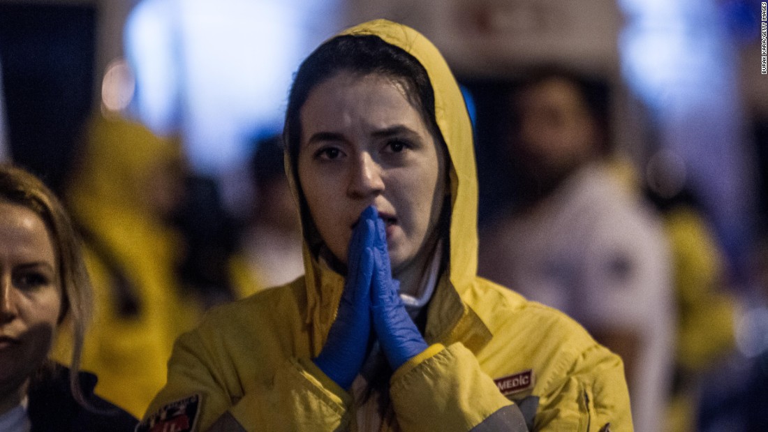 A medic reacts near the scene of the attack.