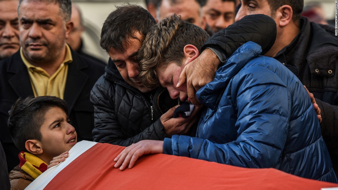 Relatives of Ayhan Arik, one of the victims of the attack, cry during a funeral ceremony in Istanbul on January 1.