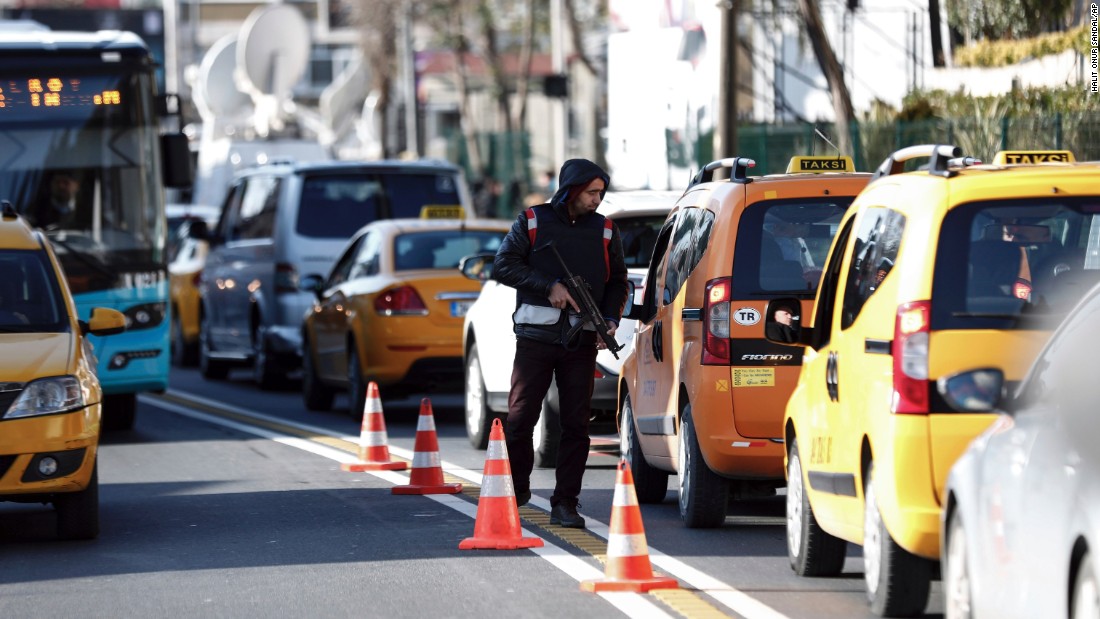 A police officer inspects cars near the scene on January 2.