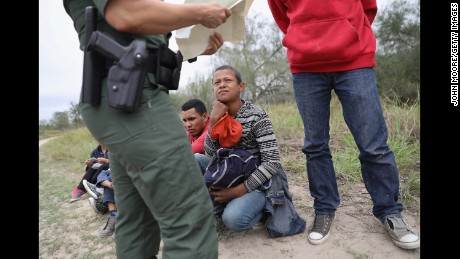 MCALLEN, TX - JANUARY 04:  A U.S. Border Patrol agent checks birth certificates while taking Central American immigrants into custody on January 4, 2017 near McAllen, Texas. Thousands of families and unaccompanied children, most from Central America, are crossing the border illegally to request asylum in the U.S. from violence and poverty in their home countries. The number of immigrants coming across has surged in advance of President-elect Donald Trump's inauguration January 20. He has pledged to build a wall along the U.S.-Mexico border.  (Photo by John Moore/Getty Images)