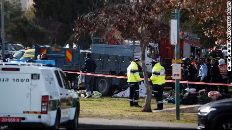 Israeli security forces gather around a flatbed truck at the site of a ramming attack in Jerusalem on January 8, 2017. 