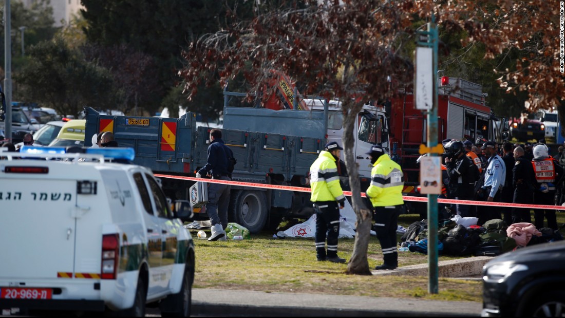 Israeli security forces gather around a flatbed truck at the site of a vehicle attack in Jerusalem on Sunday, January 8. 