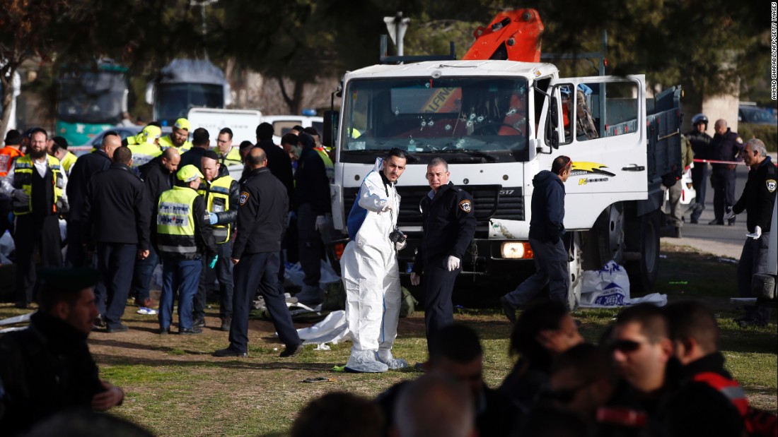 Israeli security forces and emergency personnel gather at the site of the vehicle attack. The attacker was shot and killed; note the bullet holes in the truck&#39;s windshield.