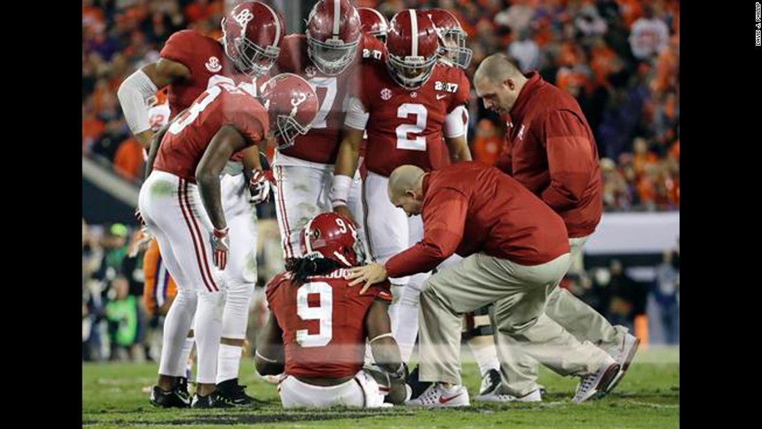 Alabama running back Bo Scarbrough is looked at by trainers after getting hurt in the second half. He didn&#39;t return to the game. Scarbrough had two touchdowns in the first half.