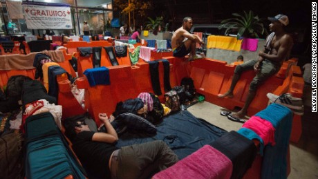 Cubans rest at the Migrations office in Penas Blancas, Guanacaste, Costa Rica, on the border with Nicaragua on November 16, 2015.  A surge of some 2,000 Cuban migrants trying to cross Central America to reach the United States triggered a diplomatic spat between Costa Rica and Nicaragua, plunging tense relations between the two countries to a new low. AFP PHOTO / Ezequiel BECERRA        (Photo credit should read EZEQUIEL BECERRA/AFP/Getty Images)