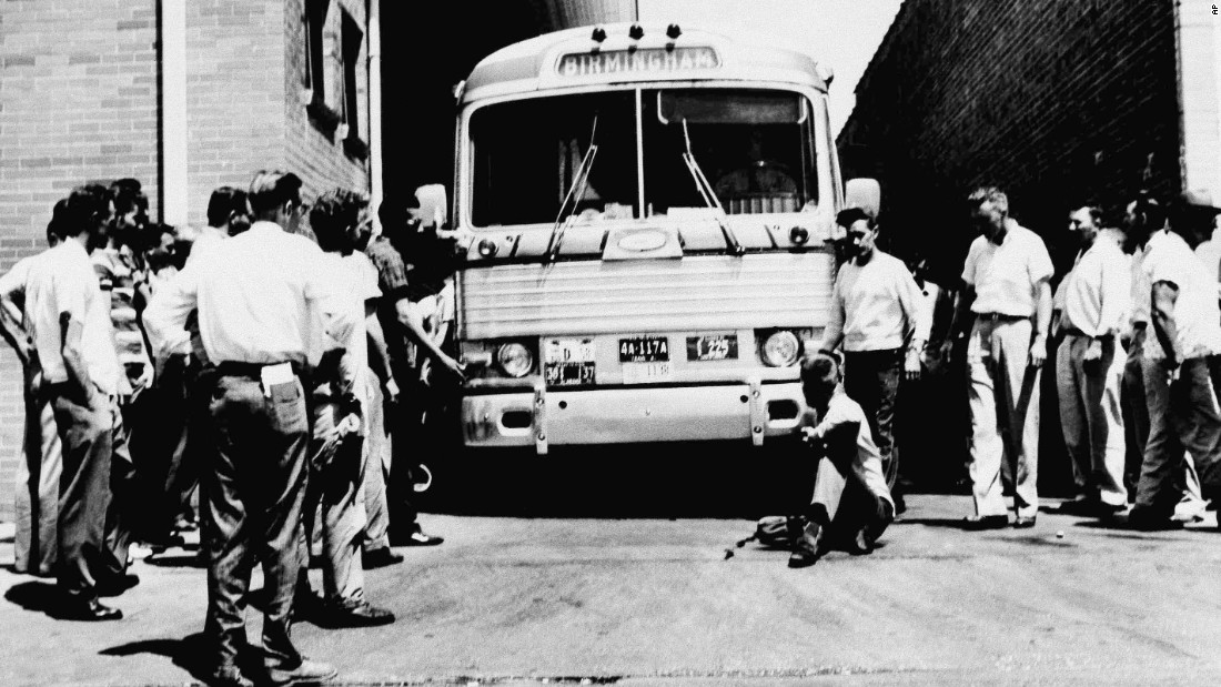 A white man in Anniston, Alabama, sits in front of a bus to prevent it from leaving the station with a load of Freedom Riders on May 15, 1961.