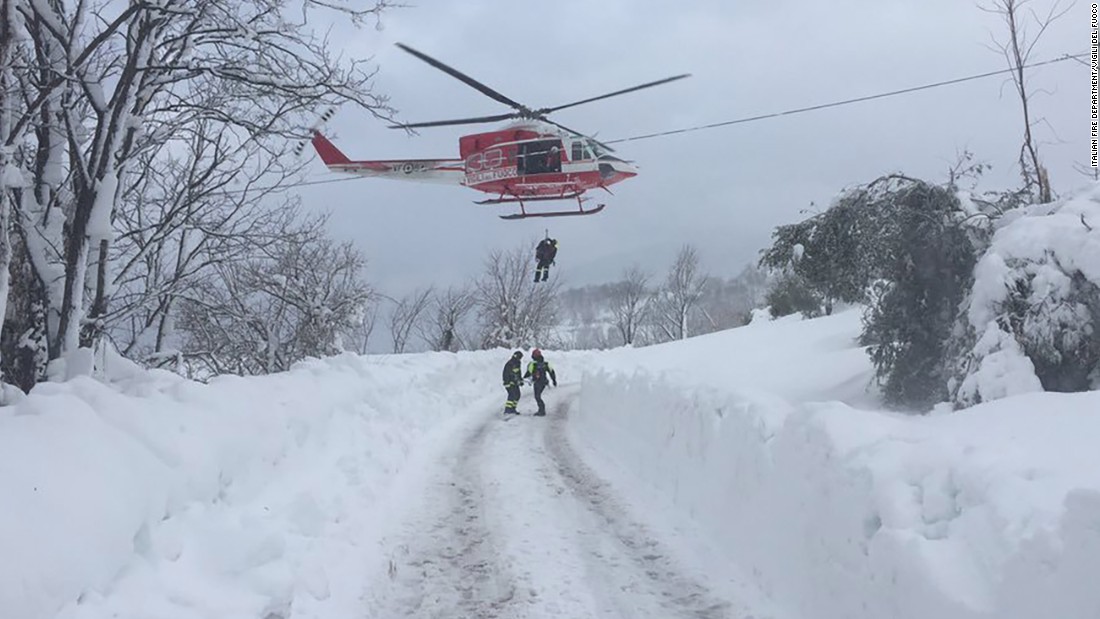 Rescuers are dropped by helicopter near the site of the avalanche. Weather conditions in the region made it difficult to access the area by road.