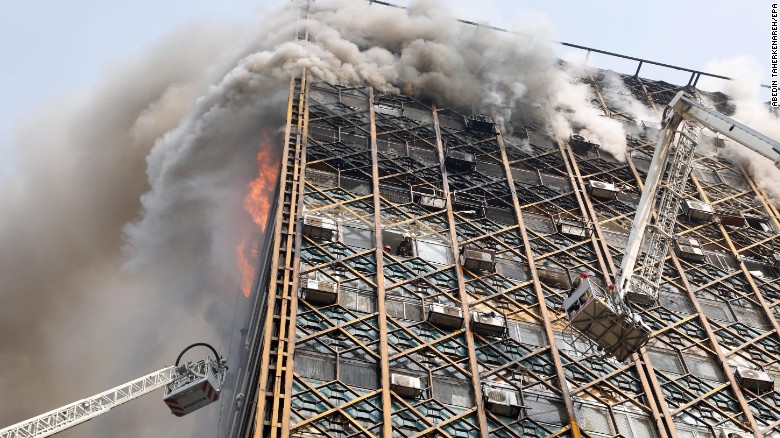 Firefighters work to control the blaze. Fars agency cited Mojtaba Doroodian, head of the shirt makers&#39; union, as saying that the fire was the result of a leak in a small gas cylinder on the 10th floor, which caused an explosion when a merchant turned on the lights in his store. Tehran Fire Department spokesman Jalal Maleki said the cause of the building fire and collapse is being investigated.