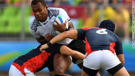 TOPSHOT - Fiji&#39;s Leone Nakarawa is tackled in the mens rugby sevens semi-final match between Fiji and Japan during the Rio 2016 Olympic Games at Deodoro Stadium in Rio de Janeiro on August 11, 2016. / AFP / Pascal GUYOT        (Photo credit should read PASCAL GUYOT/AFP/Getty Images)
