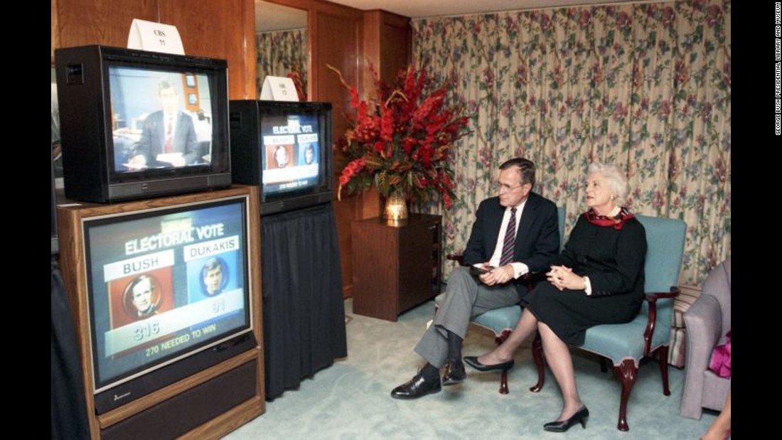 Bush sits with her husband as they watch the presidential election results in Houston on November 8, 1988. Her husband was elected the 41st President that day, with 53.1% of the popular vote and 426 electoral votes. He defeated Democratic nominee Michael Dukakis. 