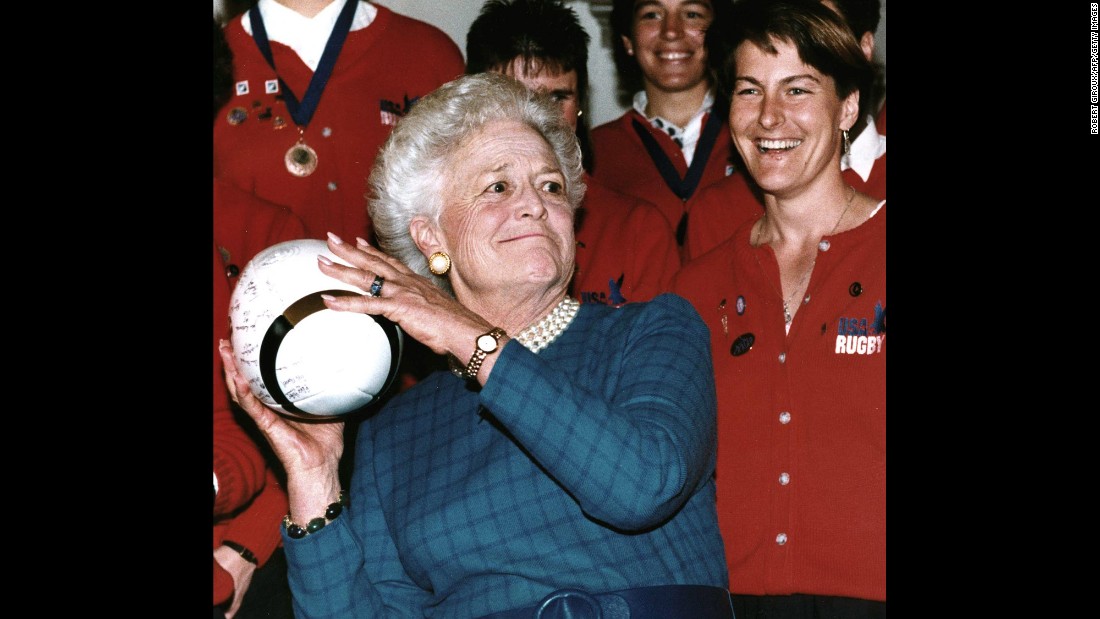 Bush prepares to throw a rugby ball after receiving it from Mary Sullivan -- captain of the US women&#39;s rugby team -- on February 7, 1992. The US team, which won the World Cup, received the Team Spirit Award from Bush.