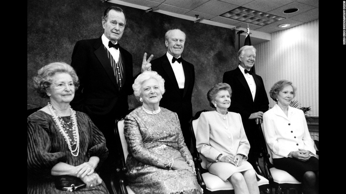 President Bush gives his wife &quot;bunny ears&quot; during an event at the Gerald R. Ford Library on April 16, 1997. Also pictured are former Presidents Ford and Jimmy Carter, as well as former first ladies Lady Bird Johnson, Betty Ford and Rosalynn Carter.