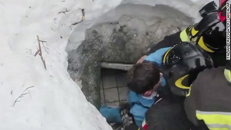 This frame from video shows Italian firefighters extracting a boy alive from under snow and debris of an hotel that was hit by an avalanche on Wednesday, in Rigopiano, central Italy, Friday, Jan. 20, 2017. (Italian Firefighters/ANSA via AP)