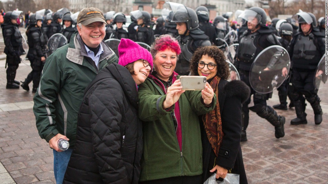 Protesters take a selfie on the grounds of the US Capitol.