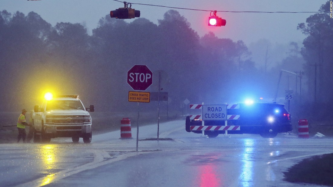 A Brooks County sheriff&#39;s deputy blocks Highway 122 near Barney as workers repair a utility pole on January 22.