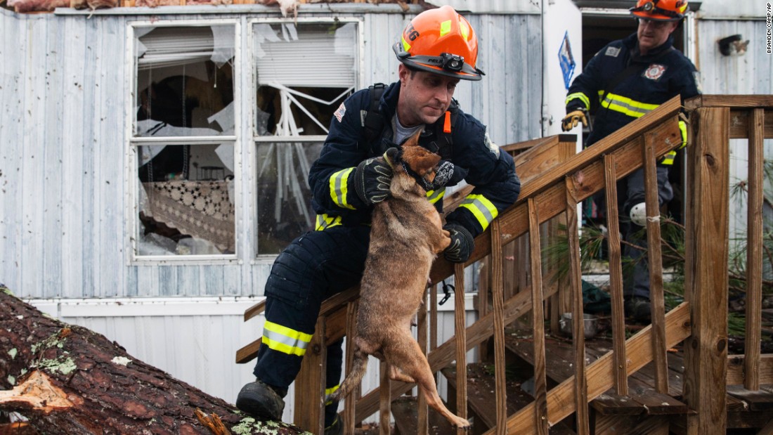 A firefighter carries a dog that was trapped inside a mobile home in Albany, Georgia, on Monday, January 23. Fire and rescue crews have been searching through the debris after &lt;a href=&quot;http://www.cnn.com/2017/01/23/us/severe-weather/index.html&quot; target=&quot;_blank&quot;&gt;severe storms&lt;/a&gt; hit southern Georgia over the weekend.