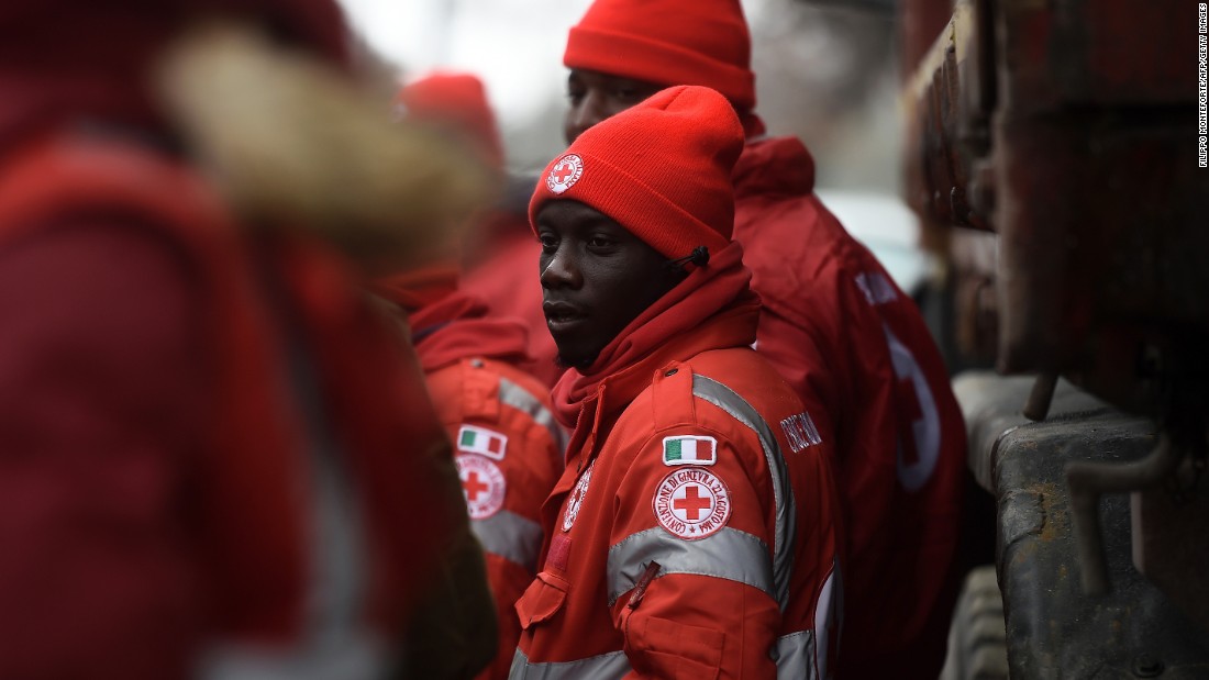 Migrants volunteering with the Italian Red Cross stand ready at the avalanche emergency operations center at Penna, central Italy, on Saturday, January 21.