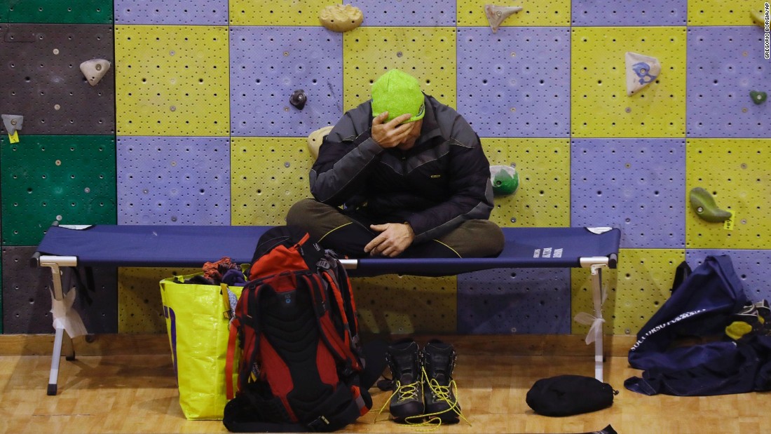 A rescuer rests at a sports complex turned emergency coordination center in Penne on January 21.