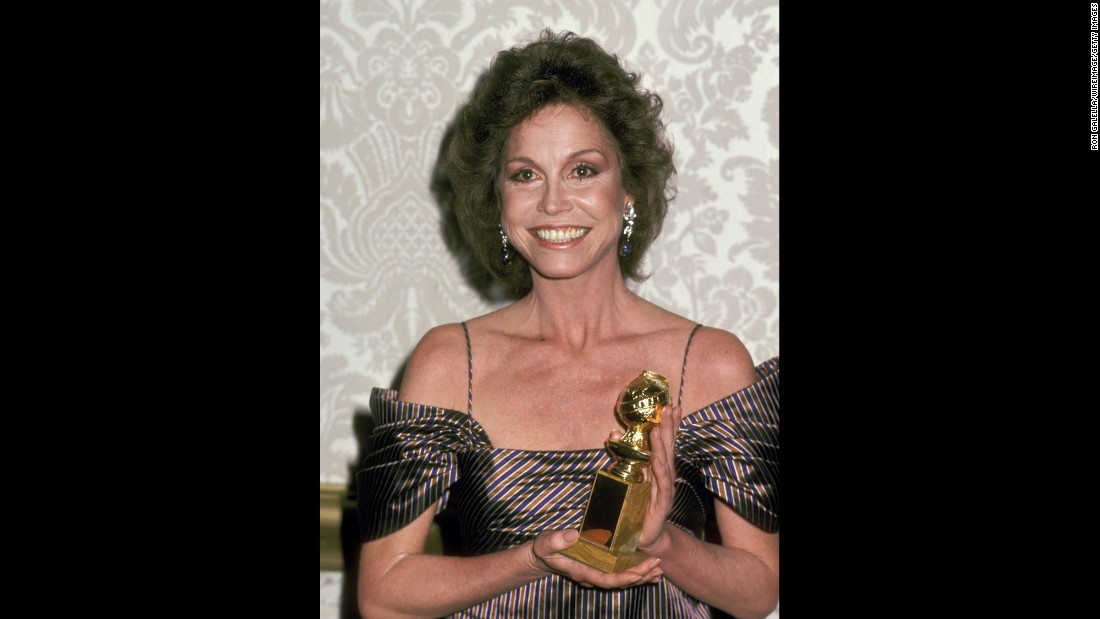 Moore holds up the Golden Globe Award she won for &quot;Ordinary People.&quot;