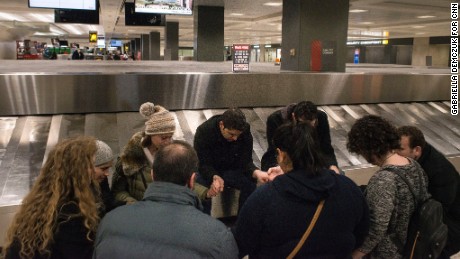 Hajouli prays with others while waiting for his wife 