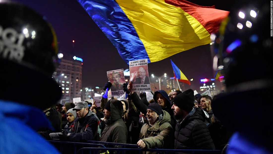 People wave flags in opposition to the government&#39;s decree February 1 in Bucharest. The embassies of Belgium, Canada, France, Germany, the Netherlands and the United States issued a joint statement expressing concern over the Romanian government&#39;s actions. The European Commission president also voiced worry.