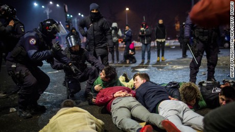 Riot police detain some protesters Wednesday in Bucharest. 