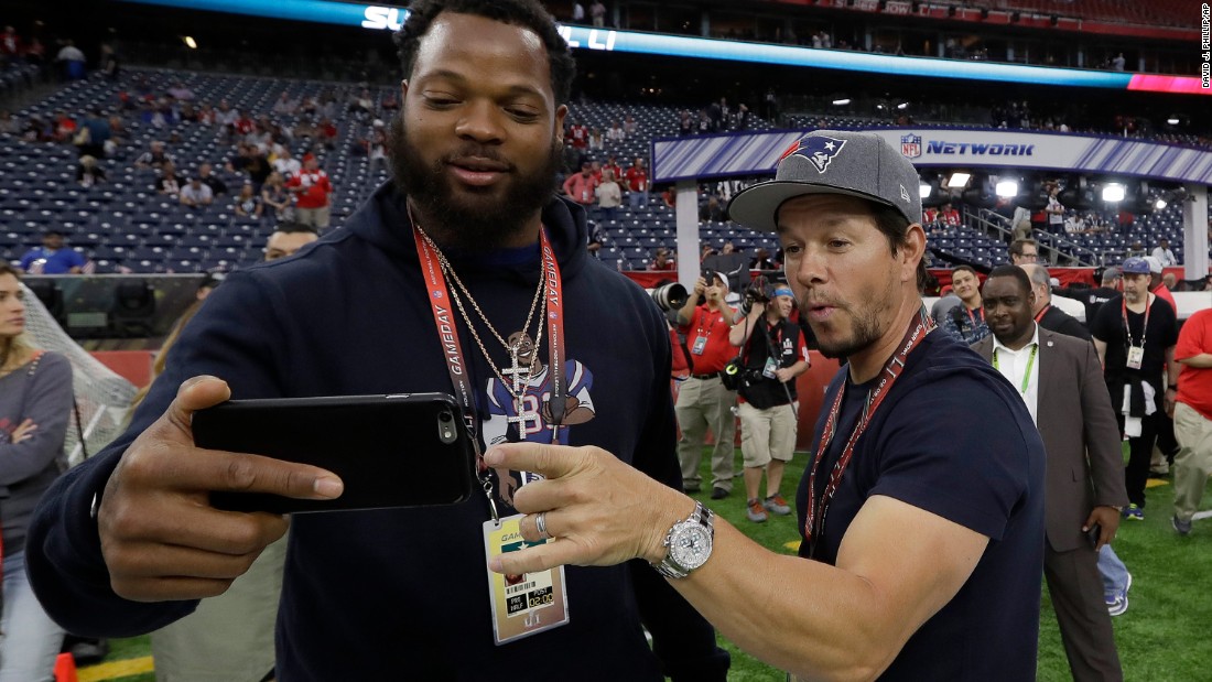 Seattle defensive end Michael Bennett takes a selfie with actor Mark Wahlberg before the game. Bennett&#39;s brother Martellus plays for the Patriots. Wahlberg is a Patriots fan.