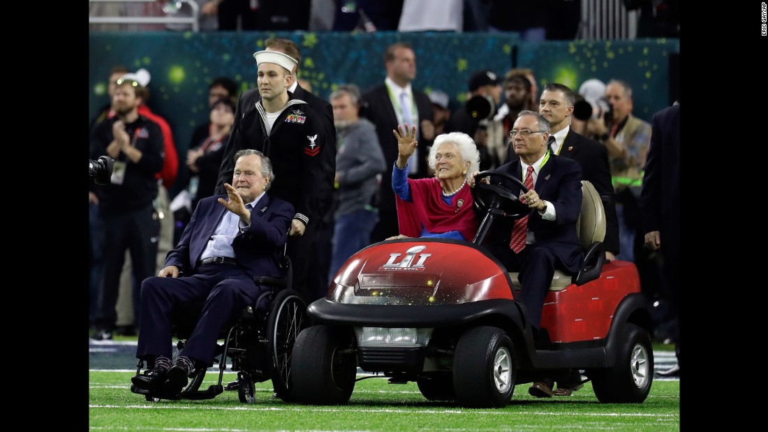 Former President George H.W. Bush and his wife, Barbara, wave as they arrive for the pregame coin toss. &lt;a href=&quot;http://www.cnn.com/2017/01/30/politics/former-president-george-h-w-bush-released-from-hospital/&quot; target=&quot;_blank&quot;&gt;They were both recently hospitalized.&lt;/a&gt;
