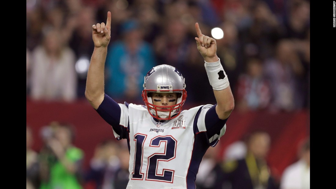 Brady raises his arms after a touchdown late in the second half.