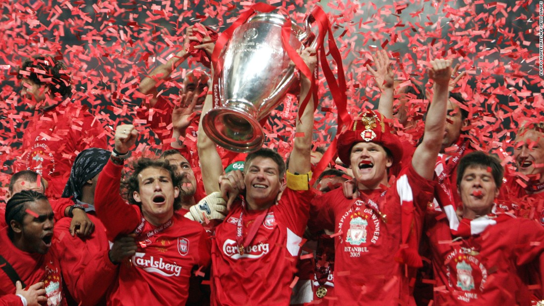 Liverpool captain Steven Gerrard holds the UEFA Champions League trophy aloft after his squad stormed back from three goals down to tie vaunted AC Milan and win on penalties in 2005.