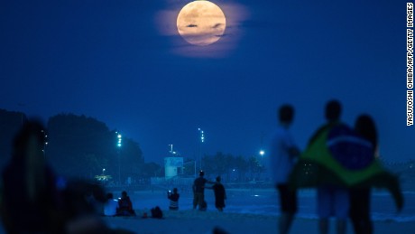 The full moon, nicknamed "the supermoon", rises at Ipanema beach in Rio de Janeiro, Brazil, on August 10, 2014. A supermoon is the coincidence of a full moon or a new moon with the closest approach the Moon makes to the Earth on its elliptical orbit, resulting in the largest apparent size of the lunar disk as seen from Earth. AFP PHOTO / YASUYOSHI CHIBA        (Photo credit should read YASUYOSHI CHIBA/AFP/Getty Images)