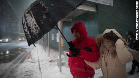 People walk through Times Square during a winter storm, February 9, 2017 in New York  / AFP / Bryan R. Smith        (Photo credit should read BRYAN R. SMITH/AFP/Getty Images)