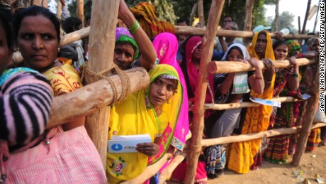 Villagers wait outside a bank to deposit and exchange large rupee notes on the outskirts of Allahabad in Uttar Pradesh. 