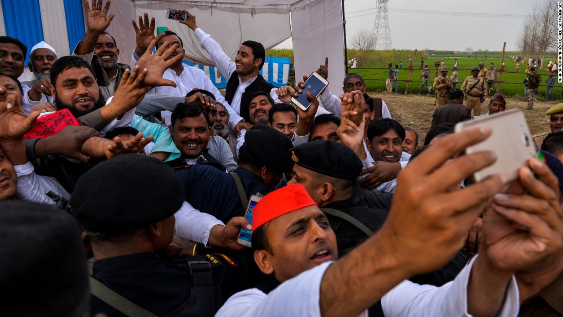 Sitting Chief Minister Akhilesh Yadav of the Samajwadi Party takes a selfie with a phone during a public rally in February 2017.
