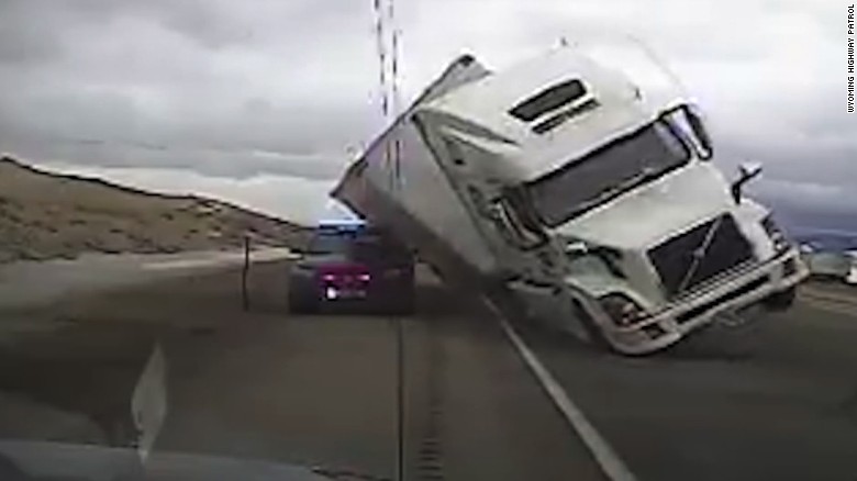 Wind slams semitrailer onto police cruiser dashcam video 