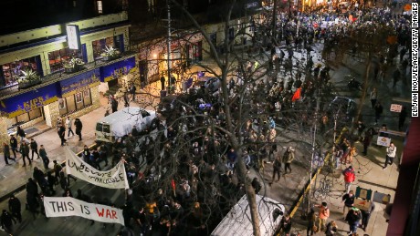 People protesting controversial Breitbart writer Milo Yiannopoulos march in the street on February 1, 2017 at UC Berkeley, California.