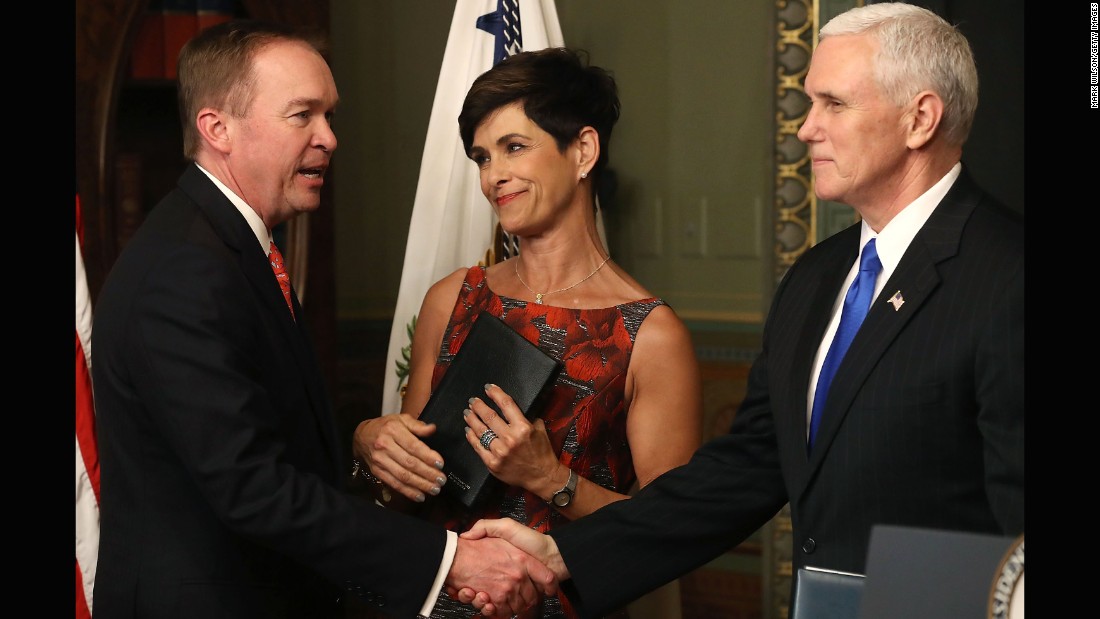 Pence shakes hands with Mick Mulvaney after swearing him in as the new director of the Office of Management and Budget on Thursday, February 16. Mulvaney&#39;s wife, Pam, looks on. Mulvaney had been a congressman since 2011.