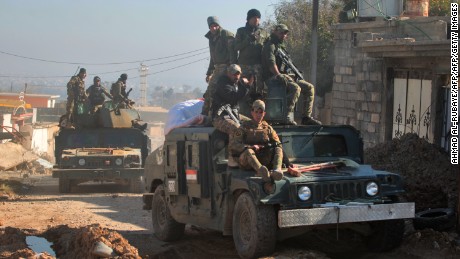 Iraqi security forces taking part in the offensive to retake the western side of Mosul from ISIS  fighters move through the village of al-Buseif on Tuesday.
