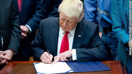 WASHINGTON, DC - FEBRUARY 16:  U.S. President Donald Trump signs H.J. Res. 38, disapproving the rule submitted by the US Department of the Interior known as the Stream Protection Rule in the Roosevelt Room of the White House on February 16, 2017 in Washington, DC.  The Department of Interior&#39;s Stream Protection Rule, which was signed during the final month of the Obama administration, &quot;addresses the impacts of surface coal mining operations on surface water, groundwater, and the productivity of mining operation sites,&quot; according to the Congress.gov summary of the resolution. (Photo by Ron Sachs-Pool/Getty Images)
