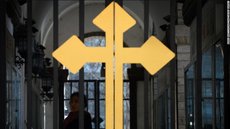 A Chinese Catholic arrives to attend a church service at the East Cathedral in Beijing on February 19, 2013.