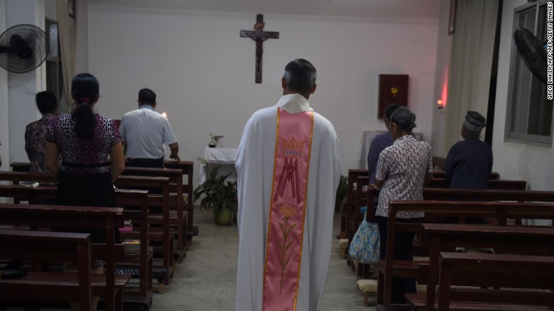 This photo taken on May 11, 2016 shows a priest about to start a mass at the Catholic church in Dingan, in China&#39;s southern Guangxi region.