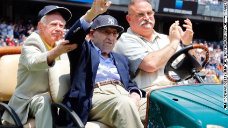 With help from former teammate New York Yankee Whitey Ford (left), former New York Yankee Yogi Berra (center) is introduced during the team&#39;s Old Timers Day in 2014.
