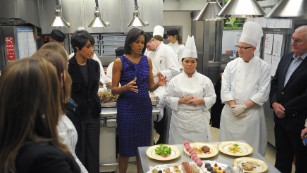 https://cdn.cnn.com/cnnnext/dam/assets/170225100937-michelle-obama-in-the-white-house-kitchen-does-a-preview-of-the-2009-governors-dinner-menu--medium-plus-169.jpg