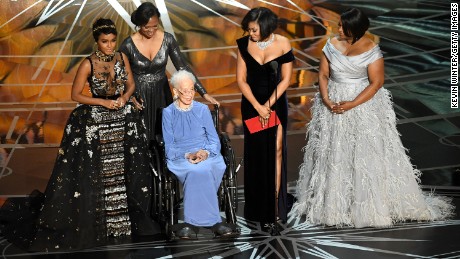 Katherine Johnson (in blue dress) was honored by &quot;Hidden Figures&quot; actors Janelle Monae, Taraji P. Henson and Octavia Spencer during the Academy Awards in 2017. Henson played Johnson in the movie. 