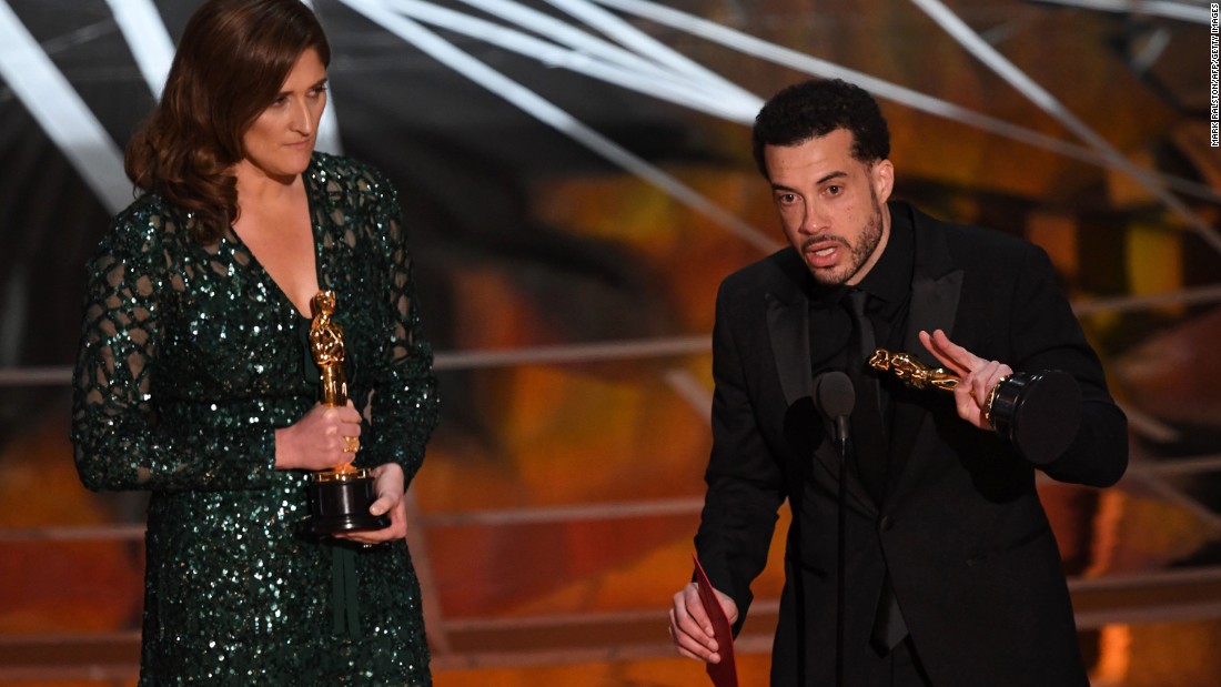 Director Ezra Edelman delivers a speech next to producer Caroline Waterlow after &quot;O.J.: Made In America&quot; won the Oscar for best documentary feature. &quot;O.J.: Made In America&quot; was a five-part miniseries that explored the life of former football star O.J. Simpson.