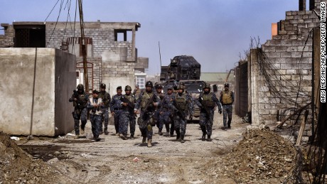 Members of the Iraqi federal police patrol Mosul during an operation to retake the city from ISIS.